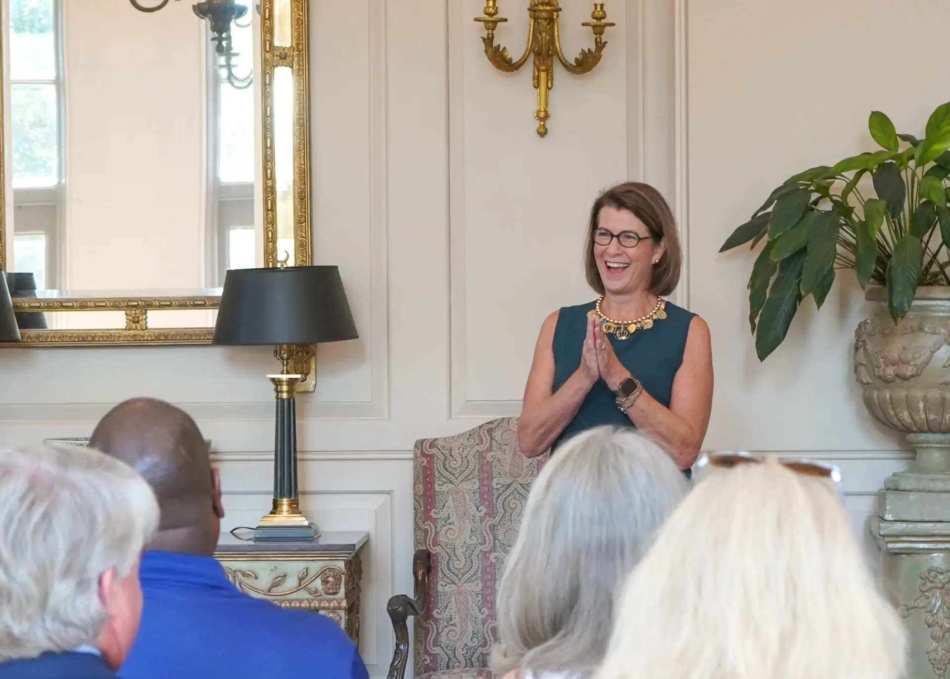 News 2 woman smiling in front of seated crowd because of a Grant awarded