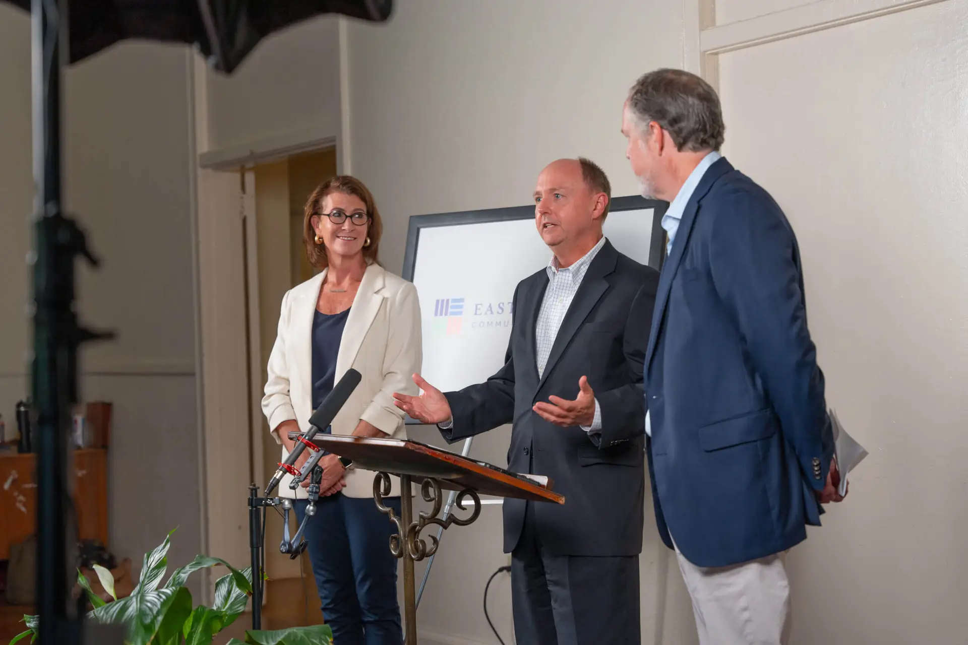 News 4 CACF and EACF representative stand speaking at a press conference