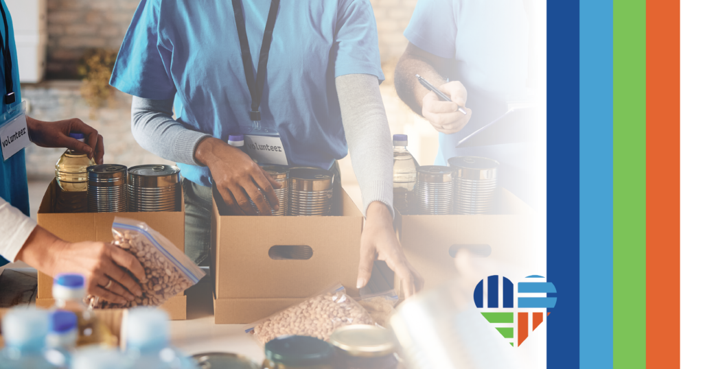 nonprofit workers filling boxes with canned food