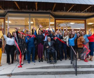 Group of people celebrating after cutting a ribbon for a new office for EACF